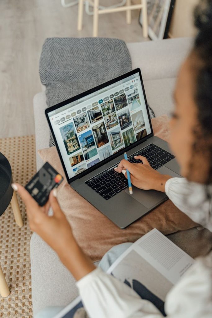 Shopper comparing holiday laptop prices on a notebook computer