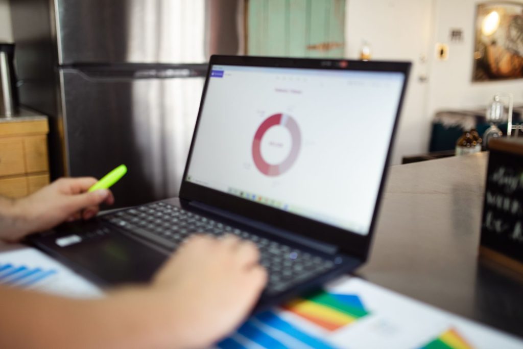 Small business owner reviewing bookkeeping dashboard on a laptop