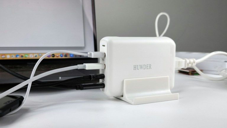 HP laptop charger plugged into an HP laptop on a desk