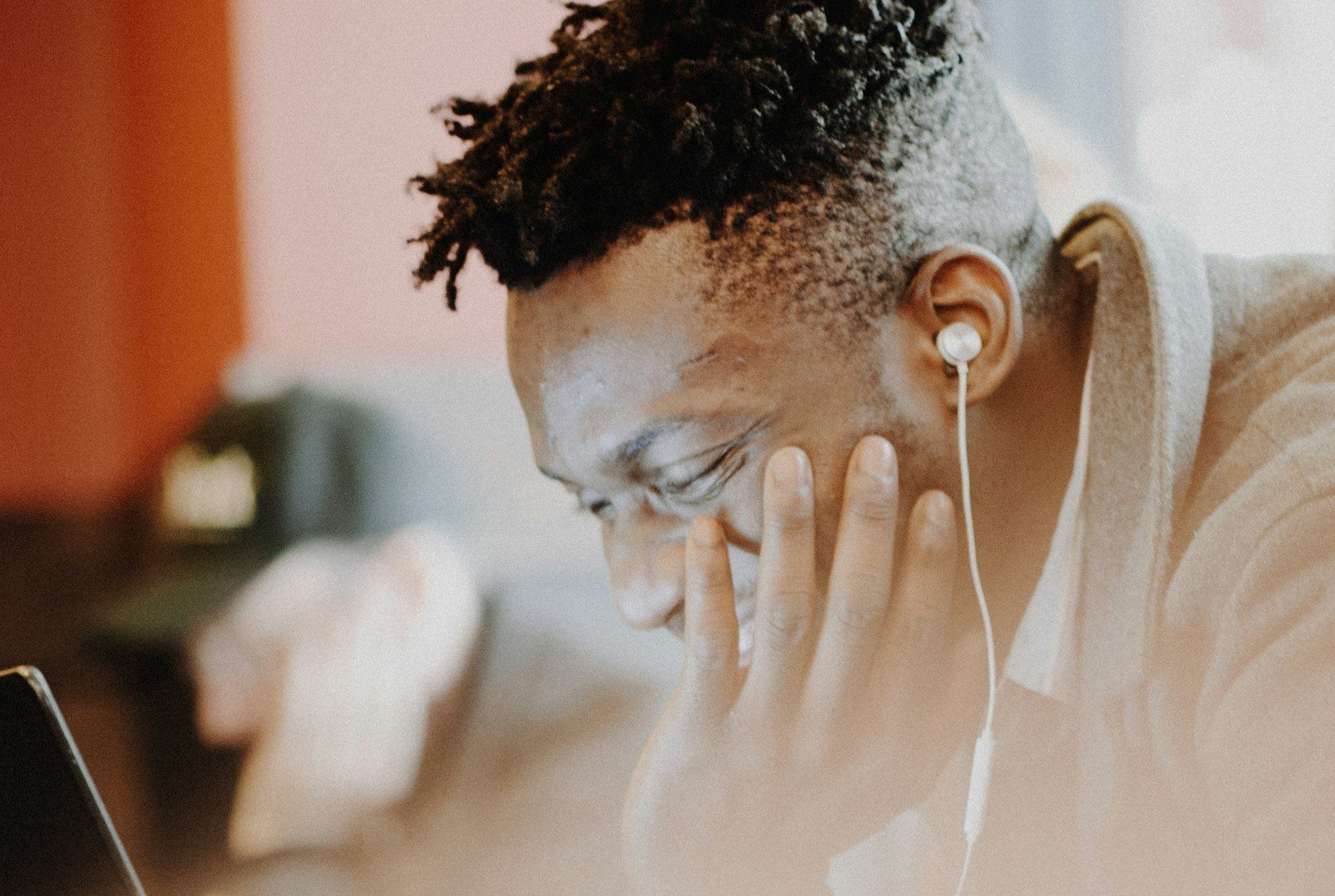 Person wearing AirPods while working on a laptop