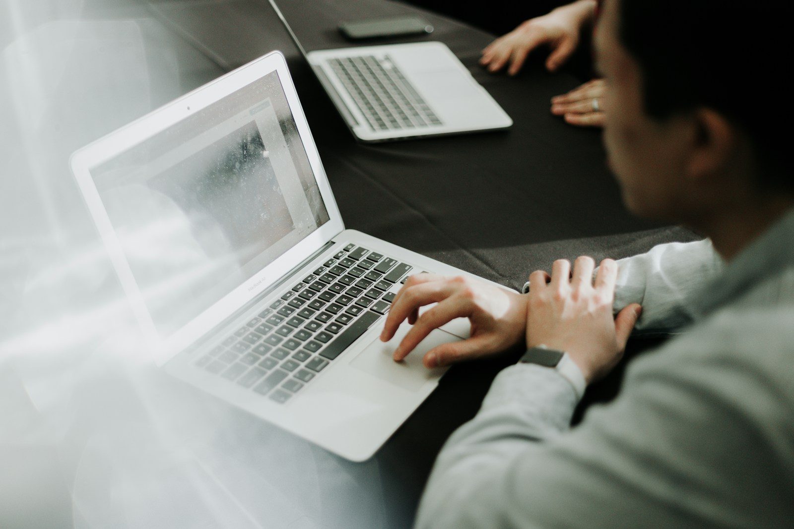 Small business owner reviewing payroll records on a laptop