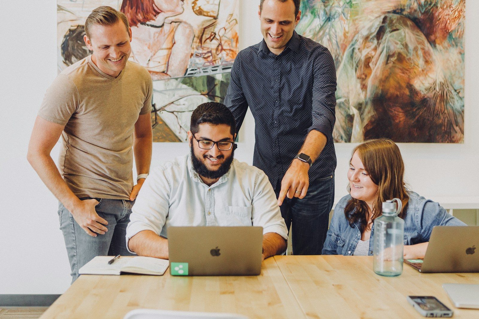 Small business team using company software tools on laptops in an office